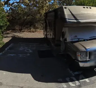 Leo Carrillo site 104, 360 photo: truck with a cab-over camper parked, faces blurred nearby